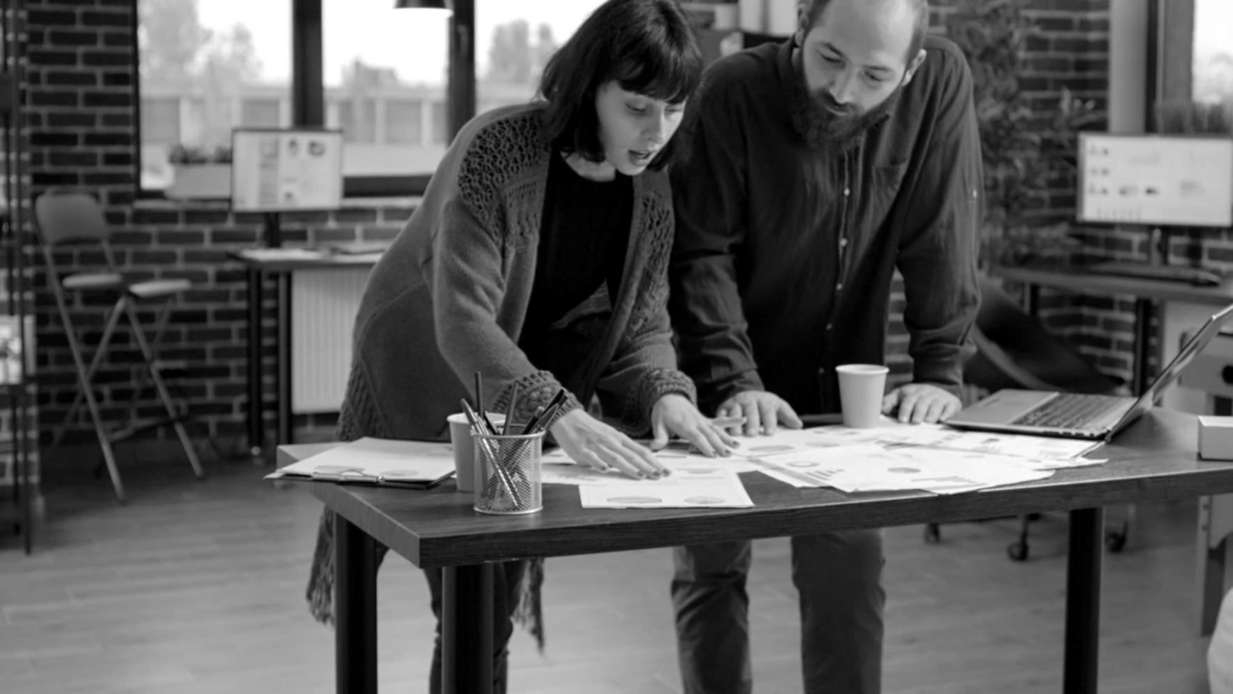 Arbeitsplatz mit Finanzunterlagen und digitalem Bildschirm